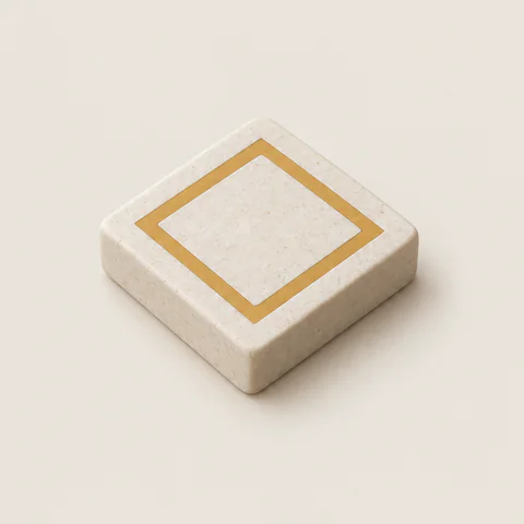 A stone tile with an ochre square inlaid in its top.